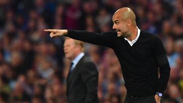 Manchester City's Spanish manager Pep Guardiola (R) and Everton's Dutch manager Ronald Koeman gesture during the English Premier League football match between Manchester City and Everton at the Etihad Stadium in Manchester, north west England, on August 21, 2017. / AFP PHOTO / Anthony DEVLIN / RESTRICTED TO EDITORIAL USE. No use with unauthorized audio, video, data, fixture lists, club/league logos or 'live' services. Online in-match use limited to 75 images, no video emulation. No use in betting, games or single club/league/player publications. /