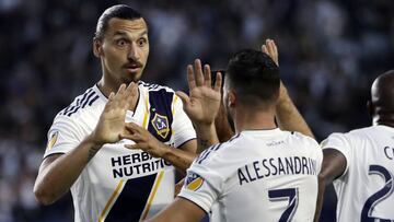 LA Galaxy midfielder Romain Alessandrini (7) celebrates his goal with teammate Zlatan Ibrahimovic during the first half of an MLS soccer match against Minnesota United, Saturday, Aug. 11, 2018, in Carson, Calif. (AP Photo/Marcio Jose Sanchez)