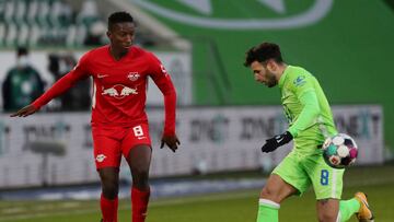 WOLFSBURG, GERMANY - JANUARY 16: Amadou Haidara of RB Leipzig is challenged by Renato Steffen of VfL Wolfsburg during the Bundesliga match between VfL Wolfsburg and RB Leipzig at Volkswagen Arena on January 16, 2021 in Wolfsburg, Germany. Sporting stadium