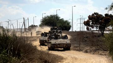 Israeli military vehicles drive near Israel's border with the Gaza Strip, in southern Israel, October 15, 2023. REUTERS/Ronen Zvulun