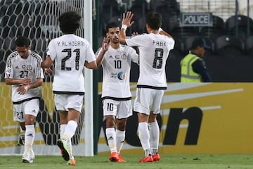 Al Jazira's Mbark Boussoufa is congratulated by team mates after scoring from the spot.