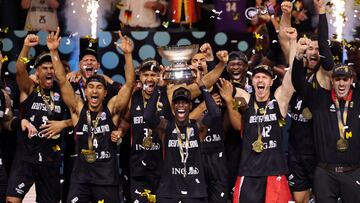 Germany's Dennis Schroder lifts the trophy as he celebrates with his teammates after winning the FIBA EuroBasket final.