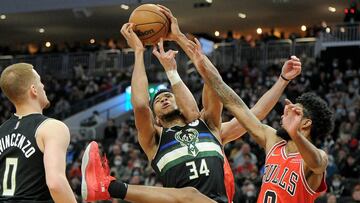 Jan 21, 2022; Milwaukee, Wisconsin, USA; Milwaukee Bucks forward Giannis Antetokounmpo (34), Chicago Bulls guard Coby White (0) and Chicago Bulls guard Alex Caruso (6) battle for a rebound in the second half at Fiserv Forum. Mandatory Credit: Michael McLoone-USA TODAY Sports