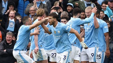 Manchester City's Norwegian striker #09 Erling Haaland (R) celebrates with teammates after scoring their third goal from the penalty spot during the English Premier League football match between Manchester City and Luton Town at the Etihad Stadium in Manchester, north west England, on April 13, 2024. (Photo by Darren Staples / AFP) / RESTRICTED TO EDITORIAL USE. No use with unauthorized audio, video, data, fixture lists, club/league logos or 'live' services. Online in-match use limited to 120 images. An additional 40 images may be used in extra time. No video emulation. Social media in-match use limited to 120 images. An additional 40 images may be used in extra time. No use in betting publications, games or single club/league/player publications. / 