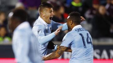 Sporting Kansas City forward Diego Rubio, left, celebrates scoring the tying goal with forward Khiry Shelton during the second half of the team's MLS soccer match against the Colorado Rapids on Saturday, March 24, 2018, in Commerce City, Colo. The teams played to a 2-2 tie. (AP Photo/David Zalubowski)