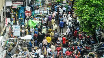 People gather for shopping from roadside vendors on a street, as a two-day lockdown is imposed every week across West Bengal state starting from July 23 to fight against the surge in COVID-19 coronavirus cases, in Kolkata on July 22, 2020. (Photo by Dibya