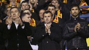 Montenegro's Prime Minister Milo Djukanovic (L), former soccer star Dejan Savicevic (C) and Mirko Vucinic watch their 2010 World Cup qualifying soccer match against Italy in Podgorica March 28, 2009. REUTERS/Stevo Vasiljevic (MONTENEGRO)