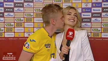 Zinchenko plants kiss on Ukrainian reporter