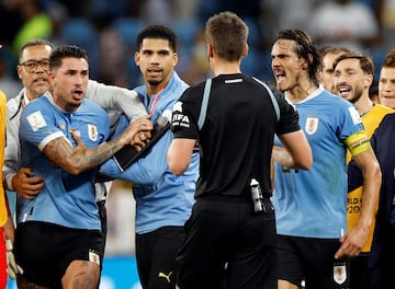 Uruguay's Jose Maria Gimenez and Edinson Cavani remonstrate with referee Daniel Siebert 