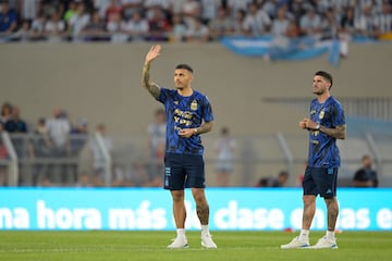 Argentina midfielders Leandro Paredes (L) and Rodrigo De Paul greet the crowd before the start of the friendly football match between Argentina and Panama at the Monumental stadium in Buenos Aires, on March 23, 2023. 