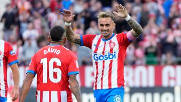 Girona's Brazilian midfielder #16 Savio Moreira celebrates with Girona's Spanish midfielder #14 Aleix Garcia scoring a goal during the Spanish league football match between Girona FC and UD Almeria at the Montilivi stadium in Girona on October 22, 2023. (Photo by Pau BARRENA / AFP)