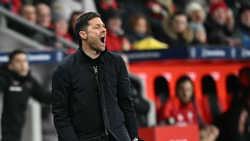 Bayer Leverkusen's Spanish head coach Xabi Alonso reacts during the German first division Bundesliga football match Bayer 04 Leverkusen v FC Bayern Munich in Leverkusen, western Germany on February 15, 2025. (Photo by INA FASSBENDER / AFP) / DFL REGULATIONS PROHIBIT ANY USE OF PHOTOGRAPHS AS IMAGE SEQUENCES AND/OR QUASI-VIDEO