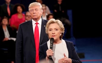 FILE PHOTO: Republican U.S. presidential nominee Donald Trump listens as Democratic nominee Hillary Clinton answers a question from the audience during their presidential town hall debate at Washington University in St. Louis, Missouri, U.S., October 9, 2016. REUTERS/Rick Wilking/File Photo