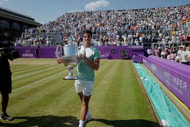 Alcaraz recorre con el trofeo la pista de hierba del Queen's Club. 