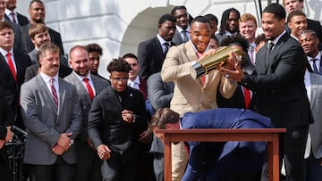 U.S. Vice President JD Vance goes to pick up part of the trophy after dropping it, as running back TreVeyon Henderson holds the other part, while Vice President Vance and President Donald Trump (not pictured) meet the Ohio State University 2025 College Football National Champions, at the White House, in Washington, D.C., U.S., April 14, 2025. REUTERS/Evelyn Hockstein