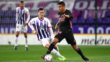 Casemiro of Real Madrid is challenged by Sergi Guardiola of Real Valladolid.