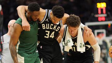 MILWAUKEE, WISCONSIN - APRIL 09: Giannis Antetokounmpo #34 of the Milwaukee Bucks is helped off the court by Thanasis Antetokounmpo #43 and Brook Lopez #11 after suffering an injury during the second half of a game against the Boston Celtics at Fiserv Forum on April 09, 2024 in Milwaukee, Wisconsin. NOTE TO USER: User expressly acknowledges and agrees that, by downloading and or using this photograph, User is consenting to the terms and conditions of the Getty Images License Agreement.   Stacy Revere/Getty Images/AFP (Photo by Stacy Revere / GETTY IMAGES NORTH AMERICA / Getty Images via AFP)