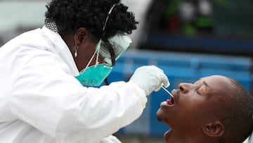 FILE PHOTO: A member of medical staff swabs the mouth of a resident as she is testing him for a virus, during a nationwide lockdown for 21 days to try to contain the coronavirus disease (COVID-19) outbreak, in Alexandra, South Africa, March 31, 2020. Pic