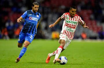 Cruz Azul's player Ignacio Rivero (L) vies for the ball with Brian Garcia (R) player of Necaxa during their Clausura 2022 tournament football match at the Azteca stadium in Mexico City, on February 12, 2022. (Photo by ALFREDO ESTRELLA / AFP)