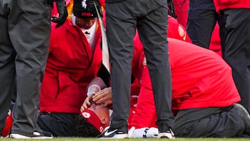 Dec 14, 2025; Kansas City, Missouri, USA; Kansas City Chiefs quarterback Patrick Mahomes (15) is attended to by team medical staff following an injury during the fourth quarter against the Los Angeles Chargers at GEHA Field at Arrowhead Stadium. Mandatory Credit: Jay Biggerstaff-Imagn Images