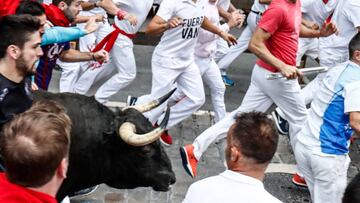 Participants run next to Jandilla fighting bulls on the fourth bullrun of the San Fermin festival in Pamplona, northern Spain on July 13, 2018. - Each day at 8am hundreds of people race with six bulls, charging along a winding, 848.6-metre (more than half