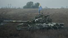 A Ukrainian flag is put on an abandoned Russian tank near Dolina in the Donetsk region, on October 10, 2022, amid the Russian invasion of Ukraine. (Photo by Yasuyoshi CHIBA / AFP) (Photo by YASUYOSHI CHIBA/AFP via Getty Images)