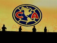 (FILES) Silhouettes of riot police officers in front of the jumbotron showing the America football club badge ahead of the Liga MX Clausura football match between America and Cruz Azul at the Sports City Stadium in Mexico City on April 12, 2025. The US investment firm General Atlantic acquired 49 percent of the shares in Mexican football club America and Banorte stadium (formerly Azteca), Grupo Ollamani announced in a statement on December 23, 2025. It will be the majority partner in this venture, which will also include the owner of an NFL team. (Photo by Alfredo ESTRELLA / AFP)