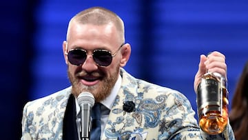 Conor McGregor speaks to the media while holding up his Notorious&#039; brand of whiskey after losing to Floyd Mayweather Jr. by 10th round TKO in their super welterweight boxing match on August 26, 2017 