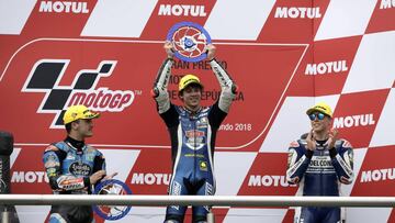 Italy's biker Marco Bezzecchi (C) celebrates on the podiun after winning the Moto3 race, next to second-placed Spain's Aron Canet (L) and third-placed Italy's Fabio Di Giannantonio (R), of the Argentina Grand Prix at Termas de Rio Hondo cir