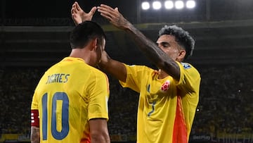 Colombia's midfielder #10 James Rodriguez celebrates scoring his team's first goal with forward #07 Luis Diaz during the 2026 FIFA World Cup South American qualifiers football match between Colombia and Bolivia at the Roberto Melendez Metropolitan stadium in Barranquilla, Colombia on September 4, 2025. (Photo by Luis ACOSTA / AFP)