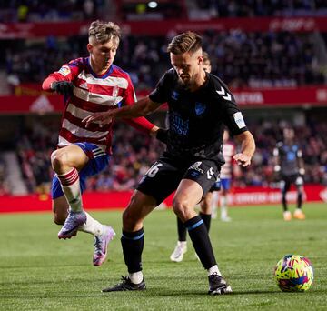 GRANADA, SPAIN - FEBRUARY 27: Bryan Zaragoza of Granada CF competes for the ball with Genaro Rodriguez of Malaga CF during the LaLiga Smartbank match between Granada CF and Malaga CF at Estadio Nuevo Los Carmenes on February 27, 2023 in Granada, Spain. (Photo by Fermin Rodriguez/Quality Sport Images/Getty Images)