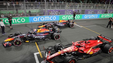 Winner Red Bull Racing's Dutch driver Max Verstappen (L), second placed Red Bull Racing's Mexican driver Sergio Perez (back) and third placed Ferrari's Monegasque driver Charles Leclerc line up their cars after the Saudi Arabian Formula One Grand Prix at the Jeddah Corniche Circuit in Jeddah on March 9, 2024. (Photo by Giuseppe CACACE / AFP)