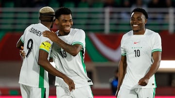 Nigeria's midfielder #18 Raphael Onyedika celebrates scoring his team's third goal with Nigeria's forward #09 Victor Osimhen and Nigeria's midfielder #10 Fisayo Dele-Bashiru during the Africa Cup of Nations (CAN) Group C football match between Uganda and Nigeria at Fes Stadium in Fes on December 30, 2025. (Photo by Abdel Majid BZIOUAT / AFP)