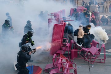 La policía dispersa a los manifestantes después de que bloquearon una calle con una barricada durante una protesta contra las redadas federales de inmigración en el centro de Los Ángeles.   