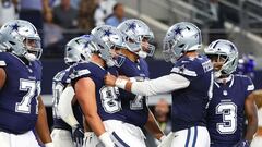 Dak Prescott #4 of the Dallas Cowboys celebrates with Jake Ferguson #87