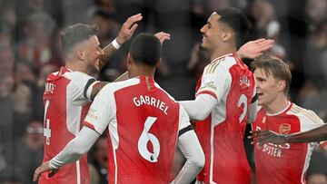 Arsenal's English defender #04 Ben White (L) celebrates with teammates after scoring their second goal during the English Premier League football match between Arsenal and Chelsea at the Emirates Stadium in London on April 23, 2024. (Photo by Glyn KIRK / AFP) / RESTRICTED TO EDITORIAL USE. No use with unauthorized audio, video, data, fixture lists, club/league logos or 'live' services. Online in-match use limited to 120 images. An additional 40 images may be used in extra time. No video emulation. Social media in-match use limited to 120 images. An additional 40 images may be used in extra time. No use in betting publications, games or single club/league/player publications. / 