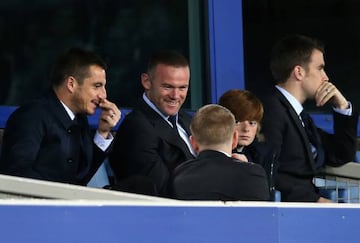 Wayne Rooney, rested against Sunderland, watches from the stands at Goodison.