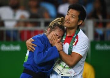 Laura Gómez es consolada por su entrenador tras no lograr pasar los octavos en judo.