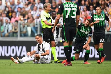 Juventus' Portuguese forward Cristiano Ronaldo (L) reacts after being tackled during the Italian Serie A football match Juventus vs Sassuolo on September 16, 2018 at the Juventus stadium in Turin. 