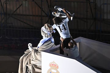 El capitán del Real Madrid Marcelo Vieira levanta la copa tras poner una bufanda a la diosa Cibeles.
