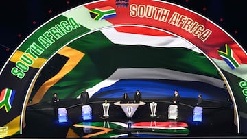 South Africa's flag is displayed on a screen during the draw for the 2026 FIFA Football World Cup taking place in the US, Canada and Mexico, at the Kennedy Center, in Washington, DC, on December 5, 2025. (Photo by Roberto SCHMIDT / AFP)