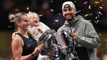 Belarus' Aryna Sabalenka (L), her goddaughter Nicole, and Australia's Nick Kyrgios celebrate with trophies at the end of the Battle of the Sexes exhibition tennis match in Dubai on December 28, 2025. (Photo by Amr Alfiky / POOL / AFP)