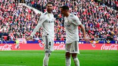 Real Madrid&#039;s Spanish defender Sergio Ramos (L) celebrates with Real Madrid&#039;s Spanish midfielder Lucas Vazquez after scoring a penalty during the Spanish league football match between Club Atletico de Madrid and Real Madrid CF at the Wanda Metro