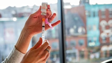 A nurse prepares a syringe with the Moderna vaccine at the East Boston Neighborhood Health Center (EBNHC) in Boston, Massachusetts on December 24, 2020. - EBNHC recently received 1400 doses of Moderna Covid-19 Vaccine, enough to vaccinate their entire sta