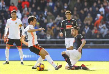 PAREJO and JAVI FUEGO battle for the ball