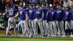 Evan Carter #32 of the Texas Rangers celebrates with teammates