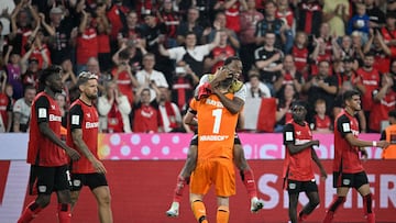 Bayer Leverkusen's players celebrate with Finnish goalkeeper #01 Lukas Hradecky after winning the penalty shoot-out of the German Supercup football match between Bayer 04 Leverkusen and VfB Stuttgart in Leverkusen, western Germany on August 17, 2024. (Photo by Sascha Schuermann / AFP) / DFL REGULATIONS PROHIBIT ANY USE OF PHOTOGRAPHS AS IMAGE SEQUENCES AND/OR QUASI-VIDEO