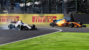 SUZUKA, JAPAN - OCTOBER 07: Lance Stroll of Canada driving the (18) Williams Martini Racing FW41 Mercedes locks a wheel under braking as Fernando Alonso of Spain driving the (14) McLaren F1 Team MCL33 Renault runs wide during the Formula One Grand Prix of Japan at Suzuka Circuit on October 7, 2018 in Suzuka.  (Photo by Clive Rose/Getty Images)