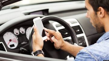 Young man using smart phone in his car