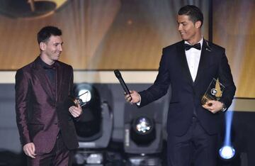 Real Madrid and Portugal forward Cristiano Ronaldo hands a microphone to Barcelona and Argentina forward Lionel Messi at the 2014 FIFA FIFPro World XI during the FIFA Ballon d'Or award ceremony.